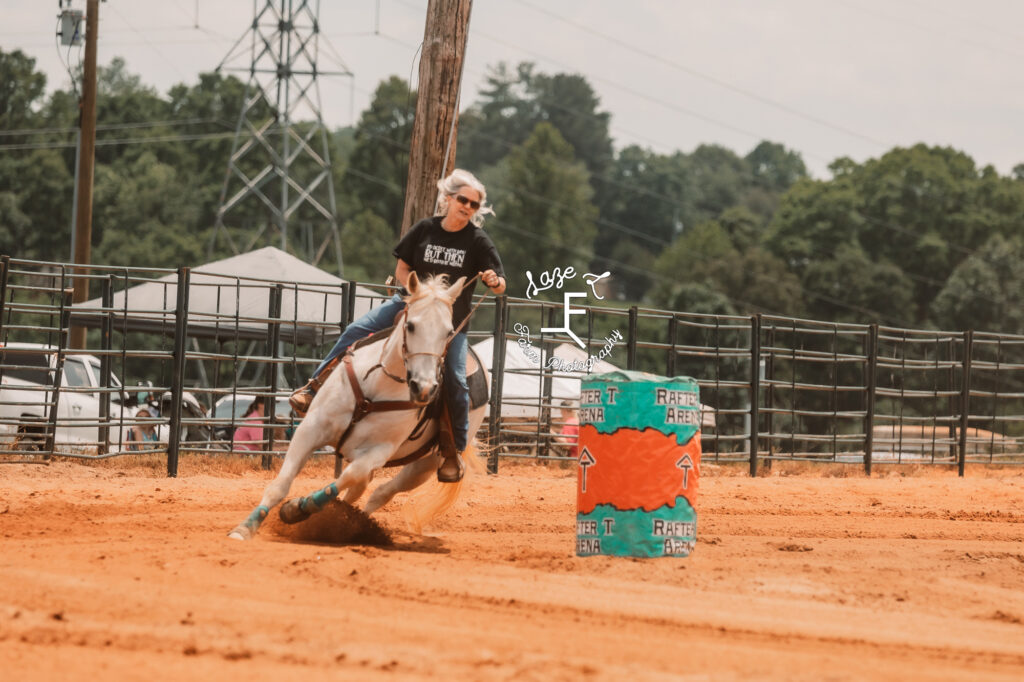 grey horse and cowgirl running barrels