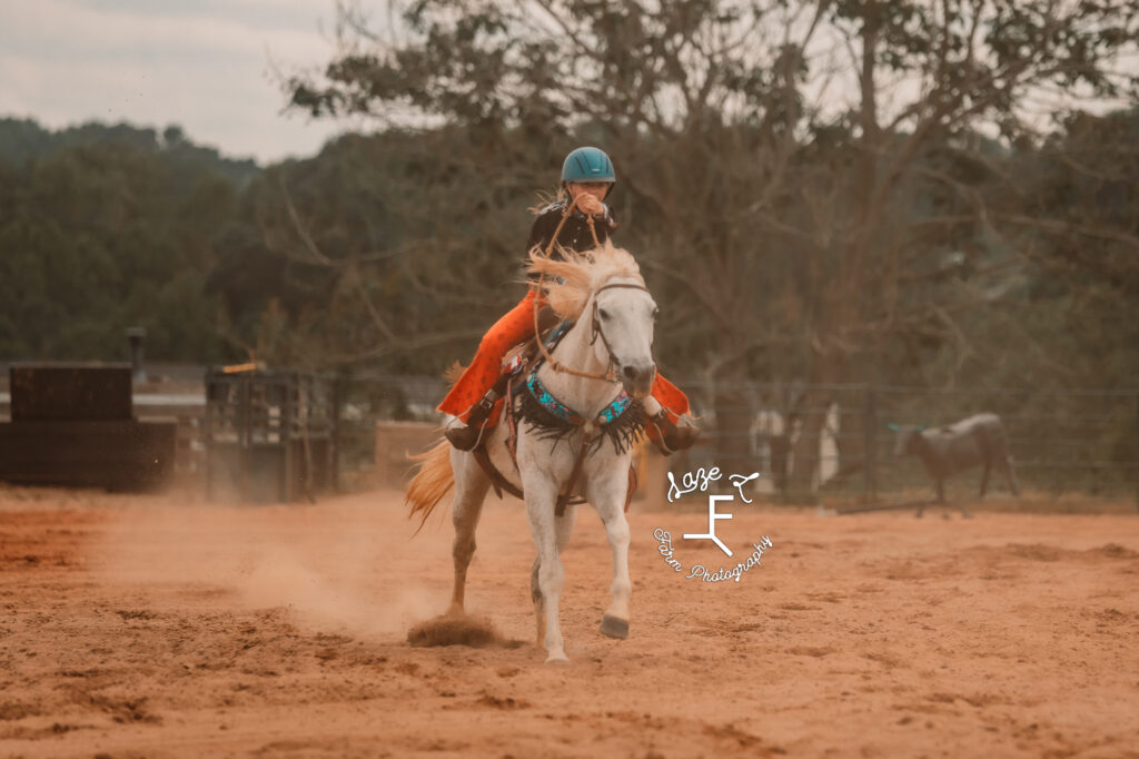 grey horse and cowgirl running barrels