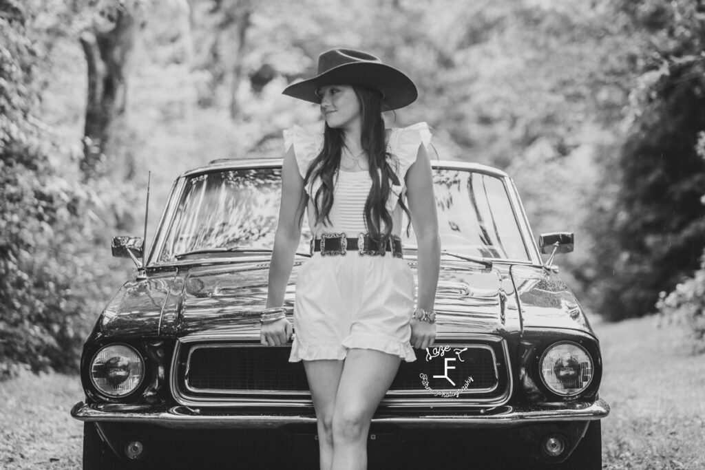 girl standing in front of car