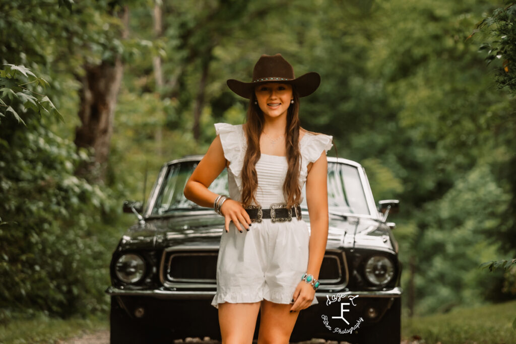 girl standing in front of car