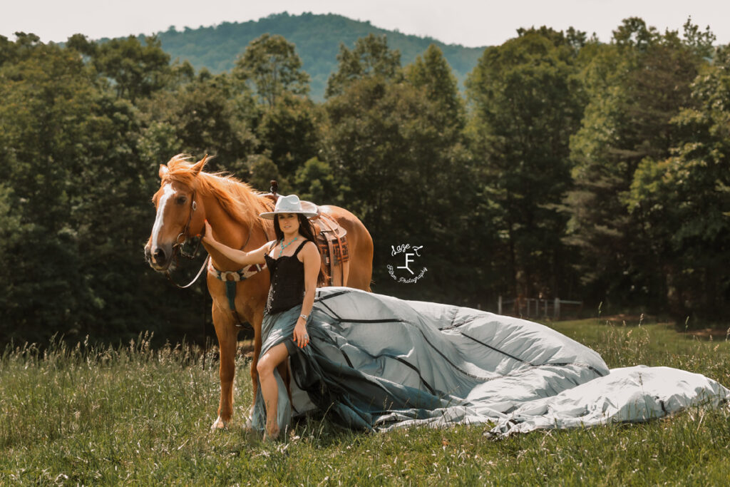 cowgirl with black parachute dress on a piano