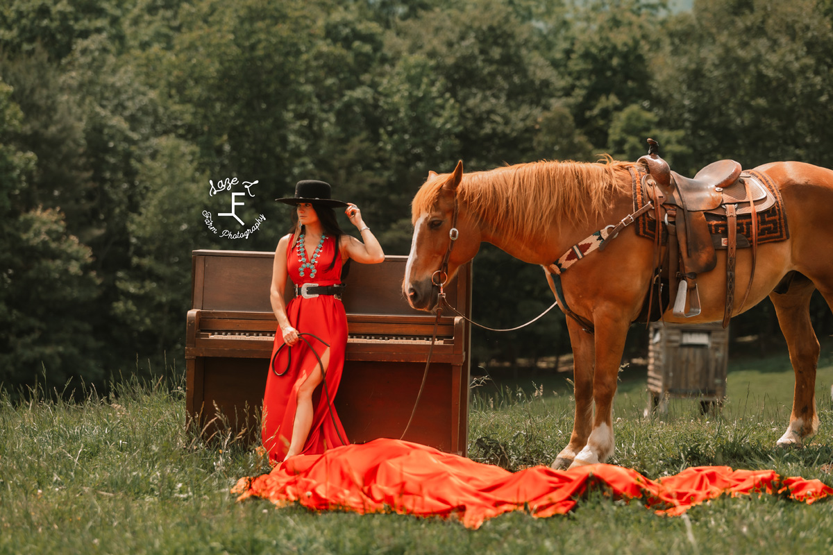 cowgirl with horse sitting on a piano with a red parachute dress