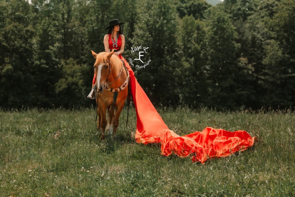 cowgirl with red parachute dress on a horse