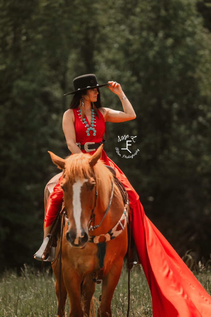 cowgirl with red parachute dress on a horse