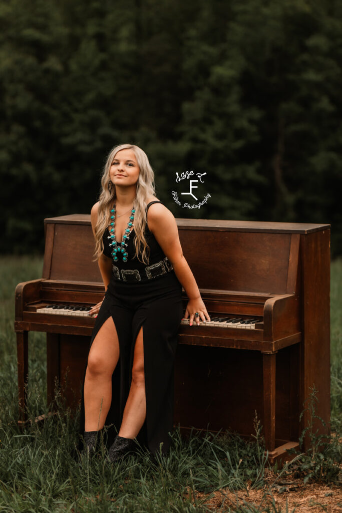 girl leaned up against a piano