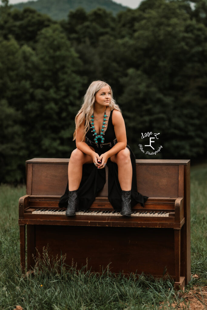 a girl leaned up against a piano