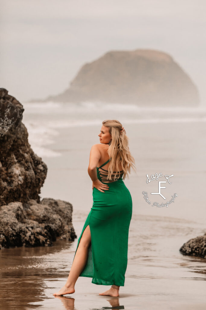 Reid standing facing away from camera on beach