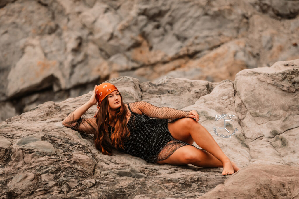 Savannah in black body suit on rocks