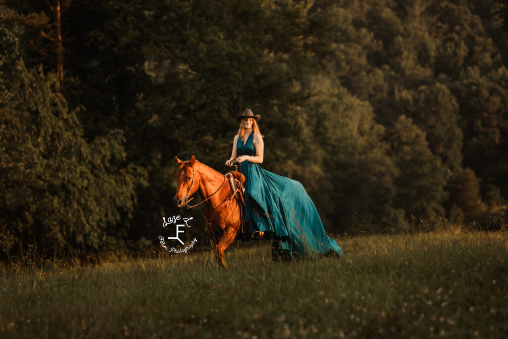 cowgirl on horse in a dress at sunset