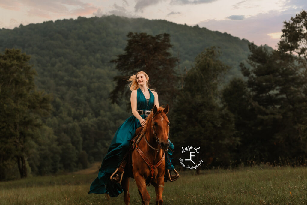 cowgirl on horse in a dress at sunset