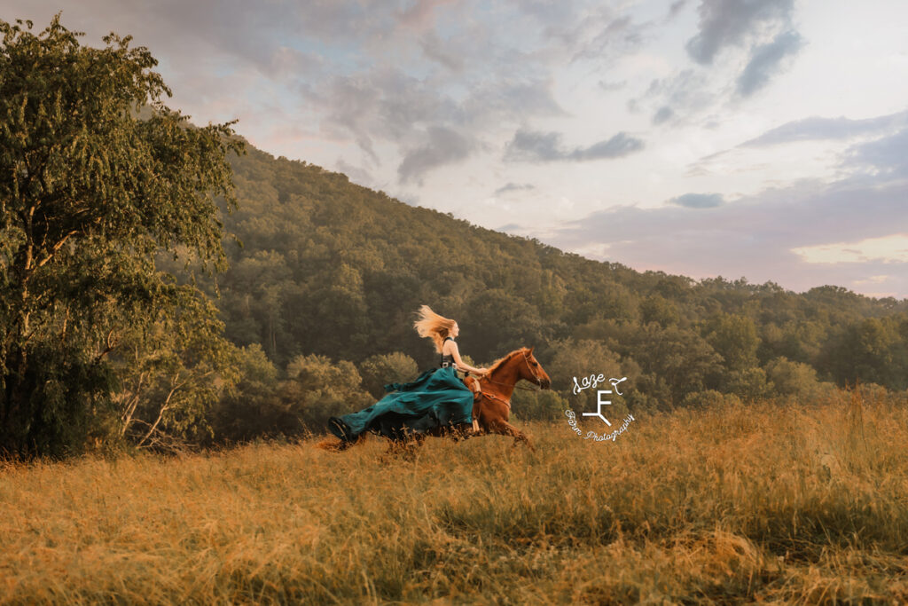 cowgirl on horse in a dress at sunset