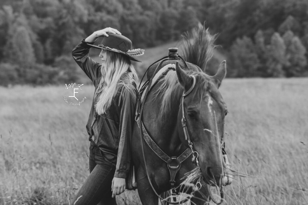 cowgirl beside horse