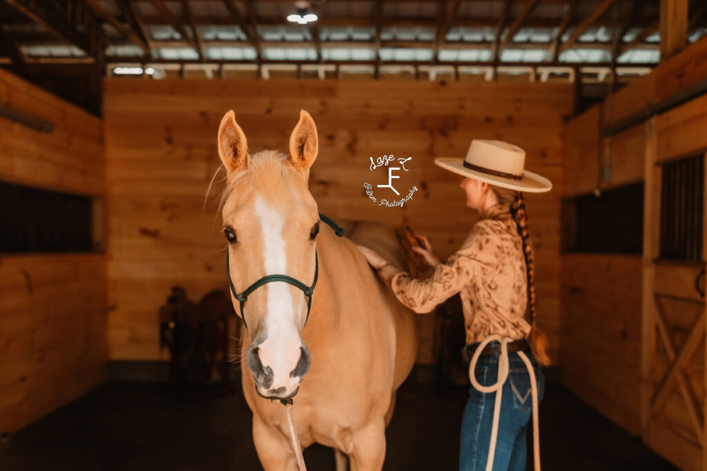 cowgirl grooming horse