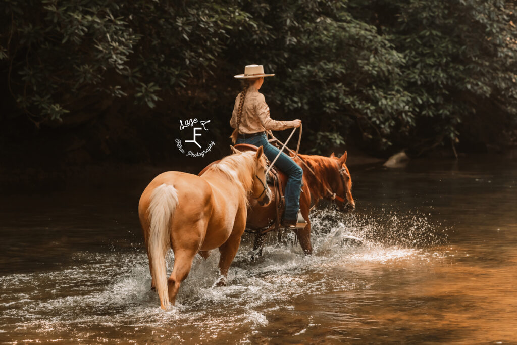 cowgirl riding in river