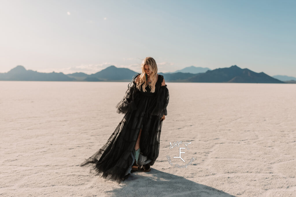 Reid walking in black dress on salt flats