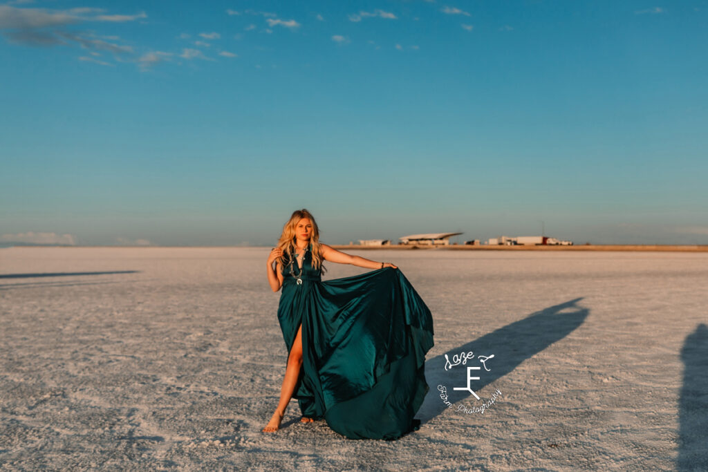 Reid in blue dress walking on salt flats