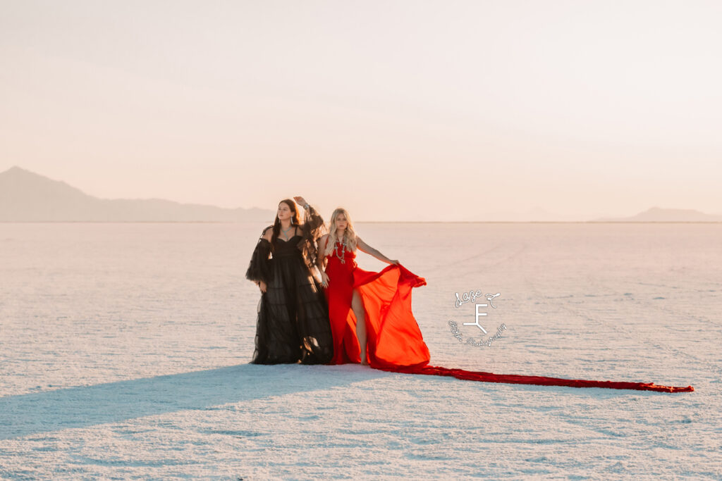 Savannah and Reid standing together in black and red dresses