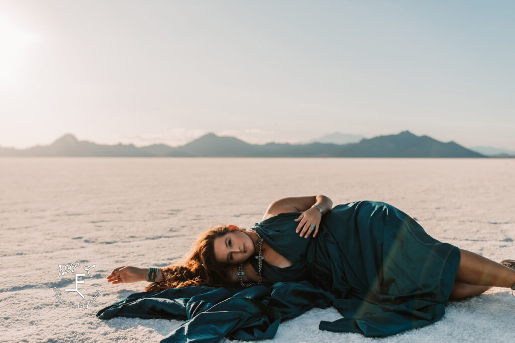 Savannah in blue dress laying on salt falts