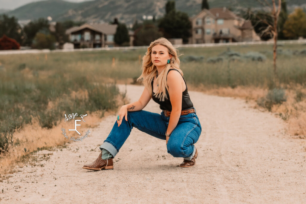 Reid squatting on dirt road