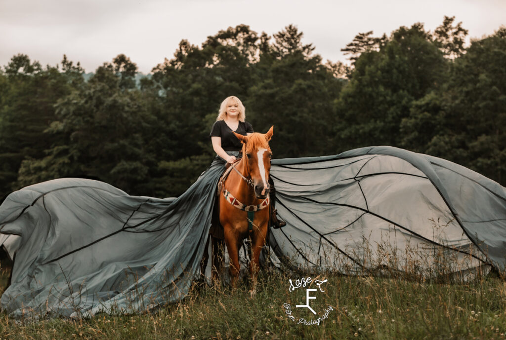 Blonde girl riding Gu with parachute dress flowing