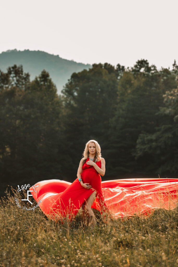 Pregnant mama holding belly in Red parachute dress