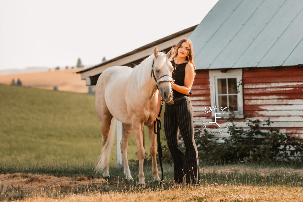 Tevis in black outfit with Palomino horse 