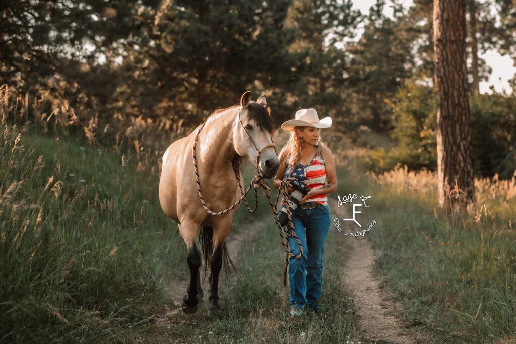 Theresa walking with her buckskin horse