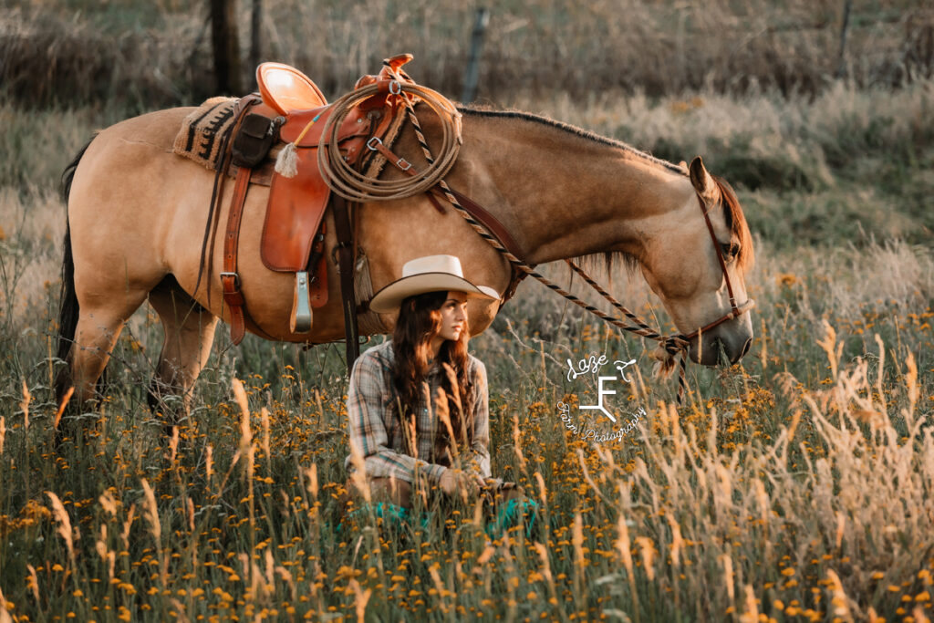 Dakota sitting with buckskin looking left