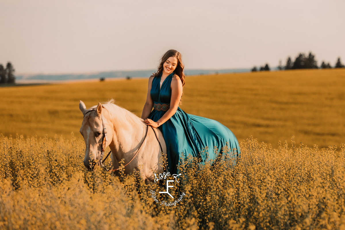 Tevis wearing blue dress riding Palomino horse bareback