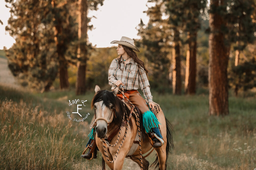 Dakota riding buckskin in chaps