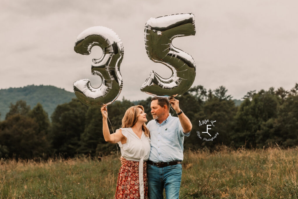 Mom and Dad holding 35 balloons and looking at each other