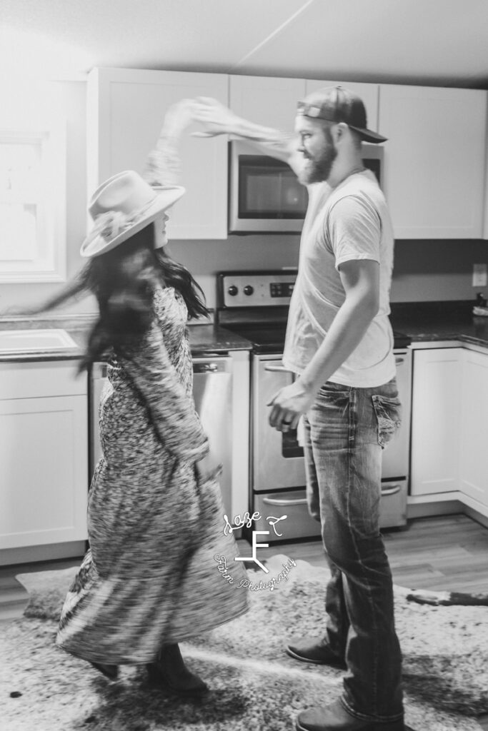 Couple dancing in the kitchen in black and white