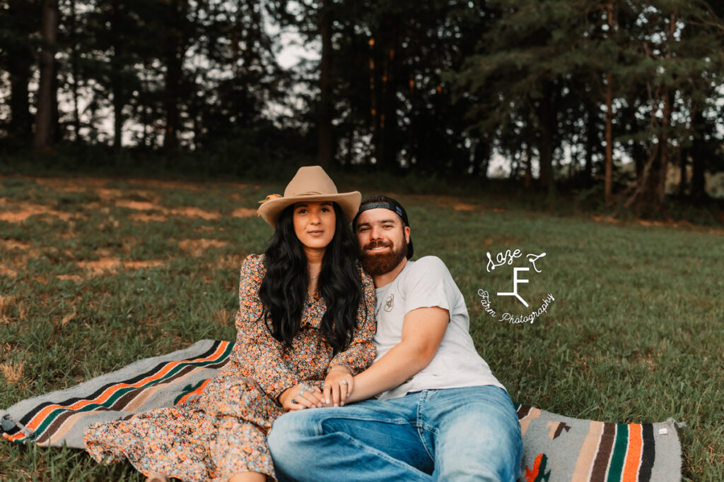 couple sitting outside on blanket together