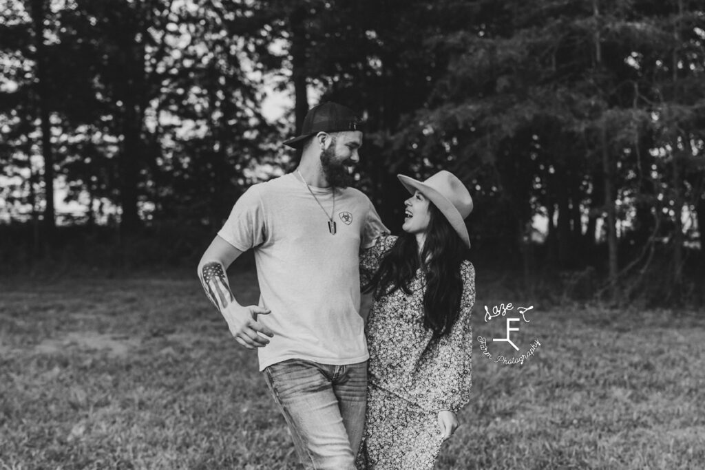 couple standing together laughing in black and white