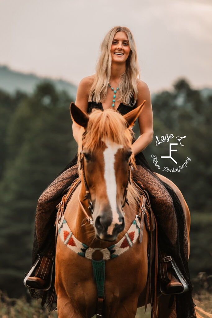 Model riding horse right at camera