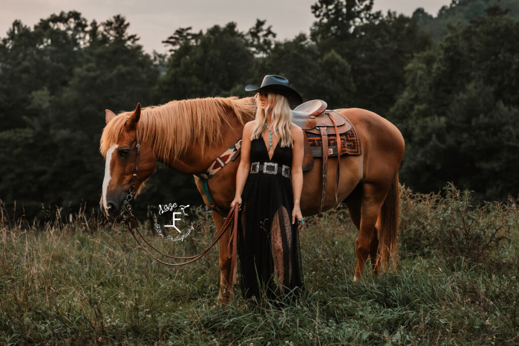 Model standing with horse looking left