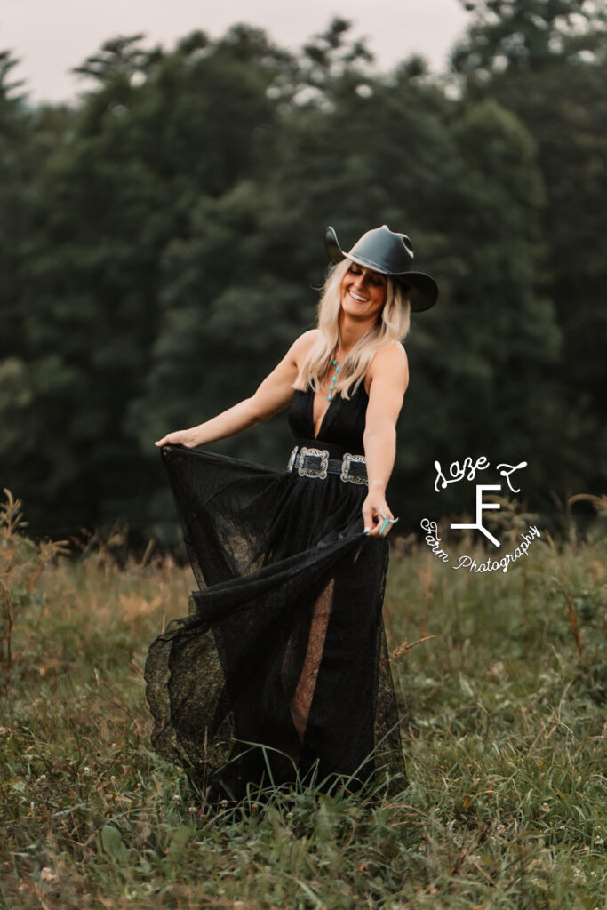 Model in black dress and hat twirling dress