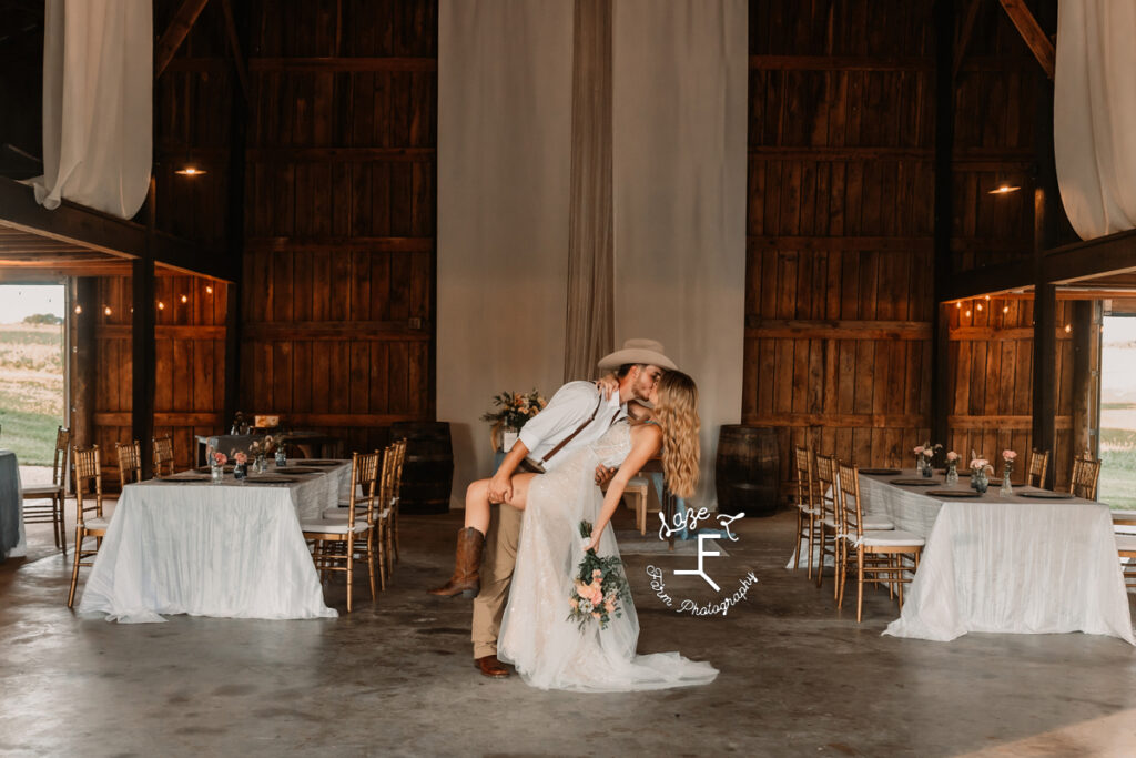 Eli and Payton doing a dip kiss in the reception space at Emerald Hill