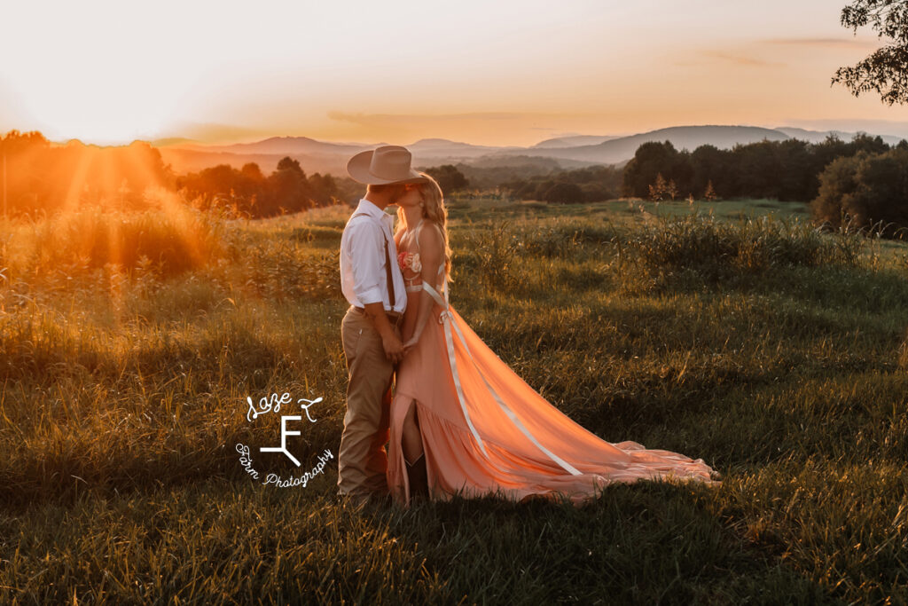 Eli and Payton kissing at sunset with mountains behind them