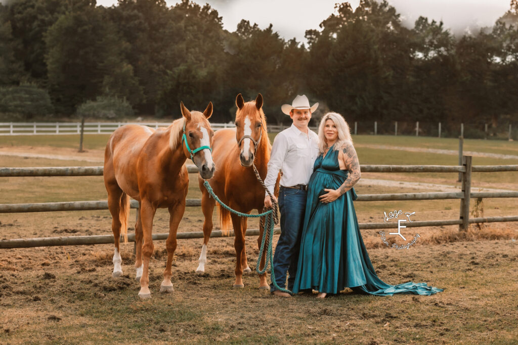 Nike in blue dress with Nate in white shirt with their 2 horses