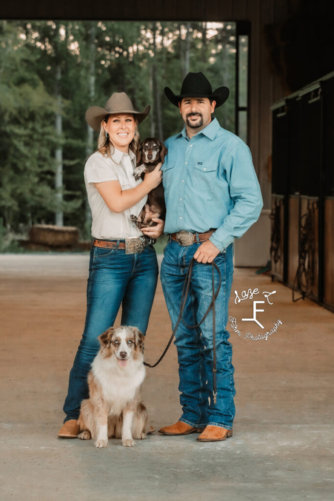 Janna and Brent with their dogs in the barn asile