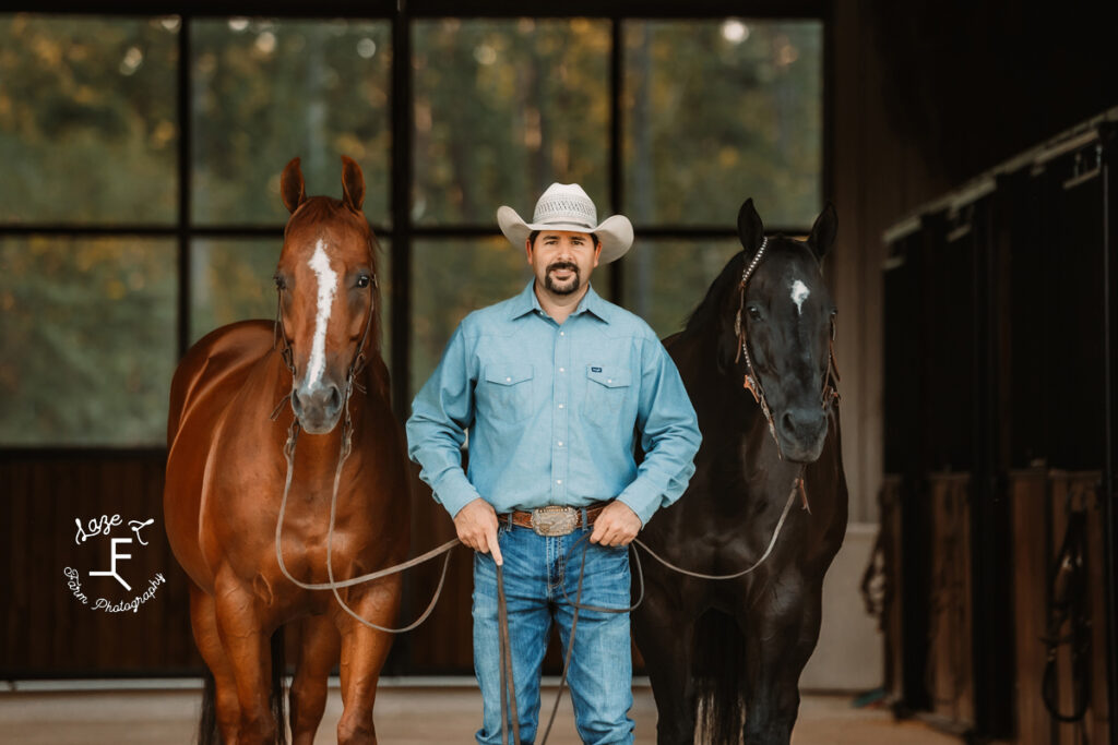 Brent with 2 horses in the barn aisle