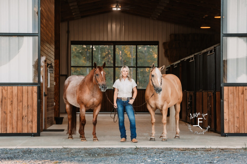 Janna with 2 horses in the barn aisle