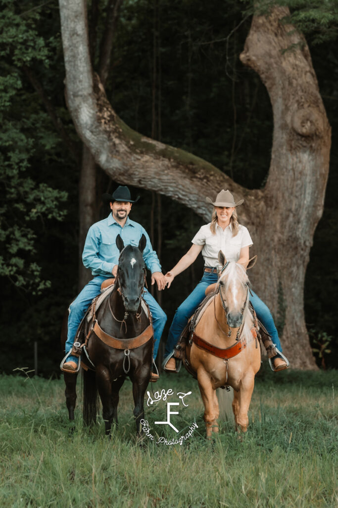 Janna and Brent riding their black and palomino horses