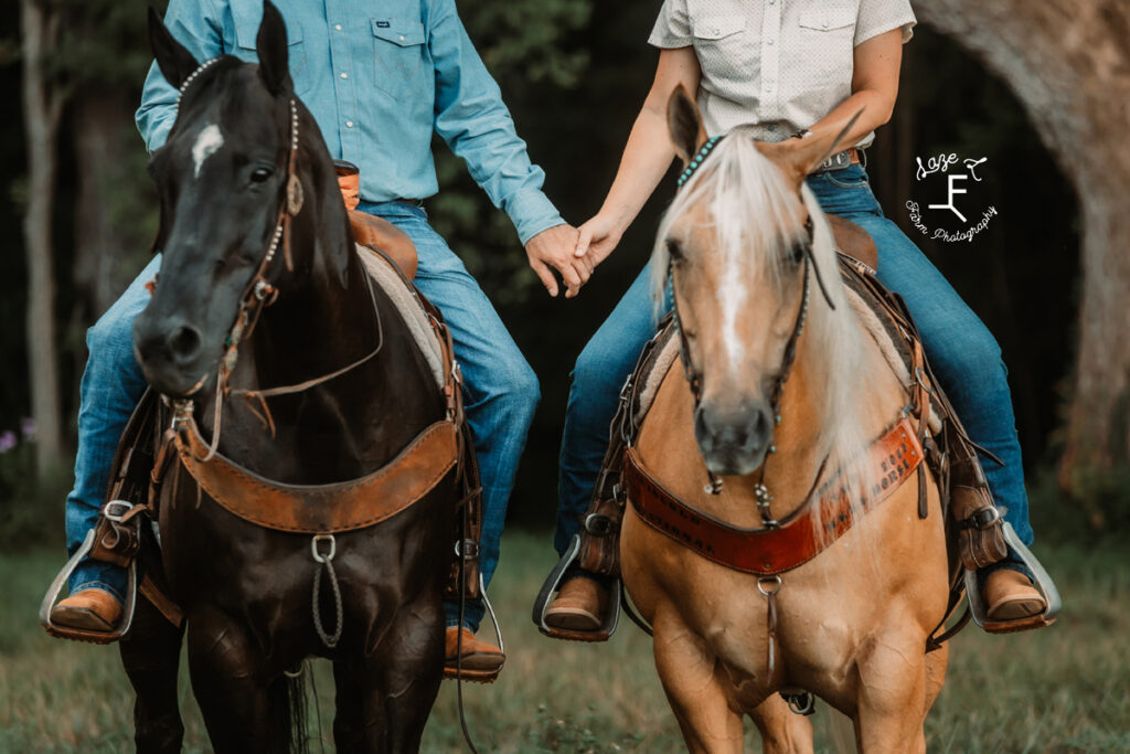 Janna and Brent holding hands on horseback