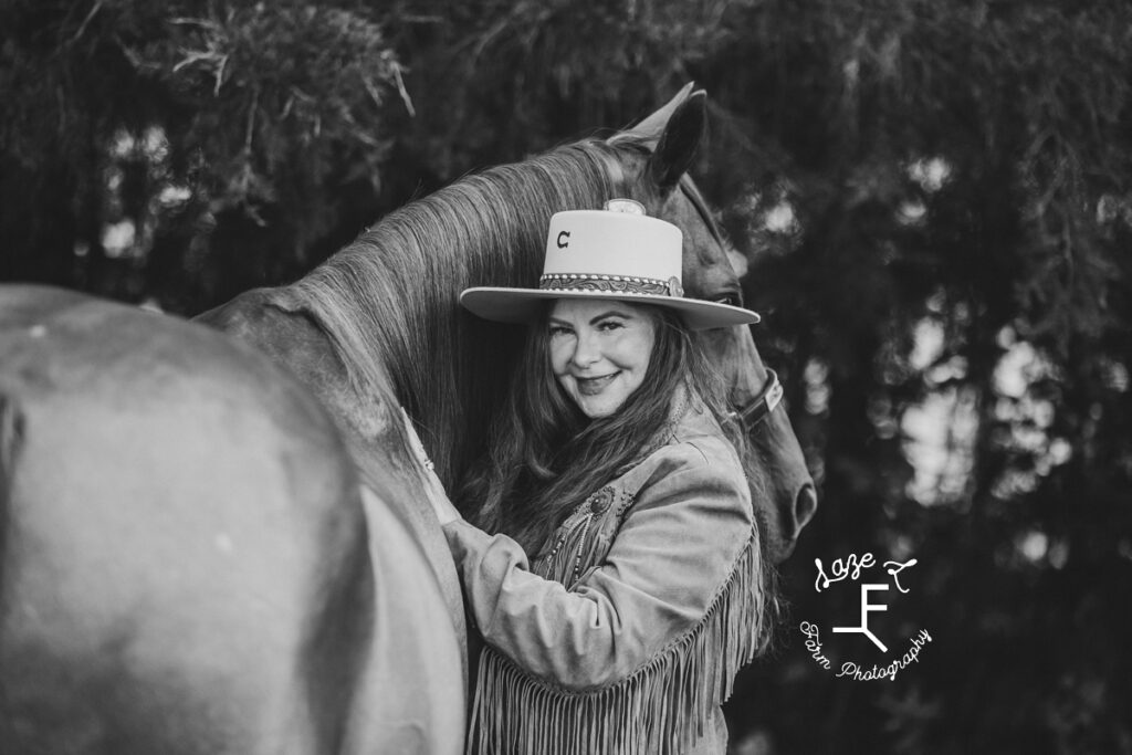 Heather standing with horse in black and white