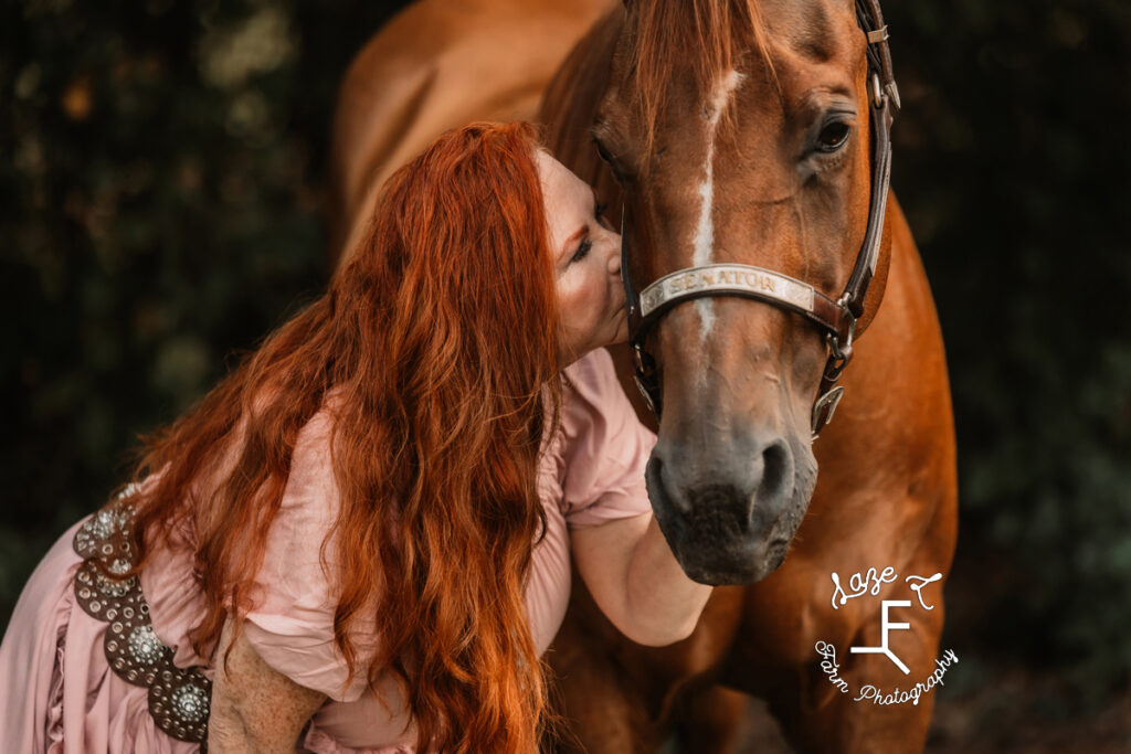 Heather kissing horse close up