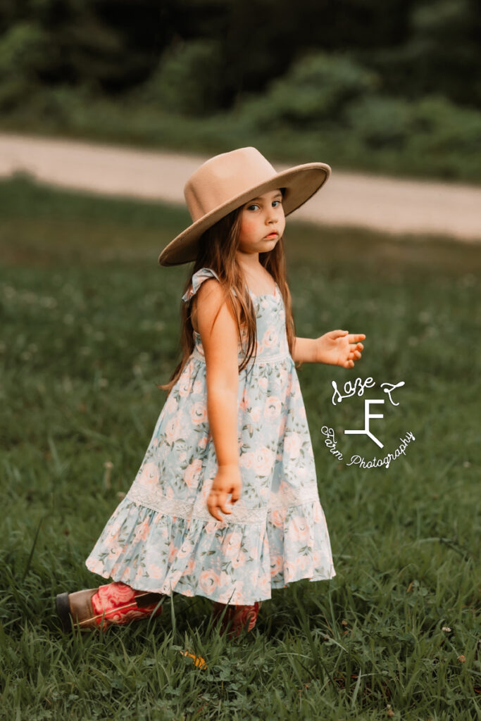 Josie walking in her dress and hat