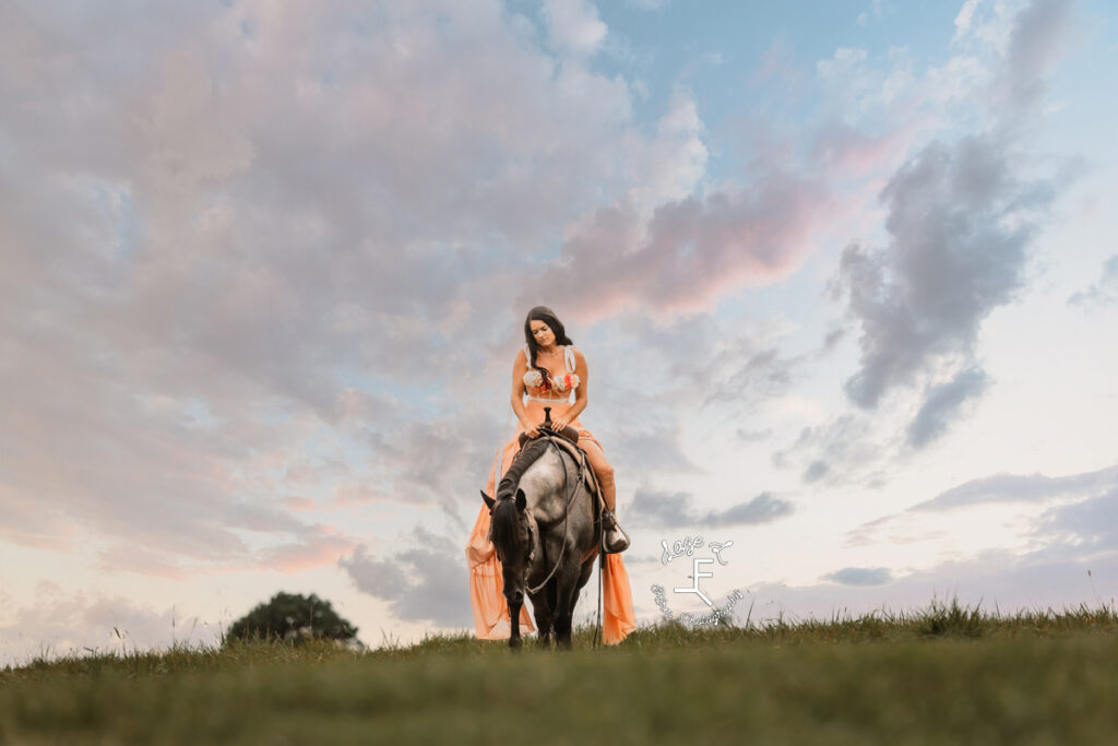 Danielle and Chex on top of a hill at sunset