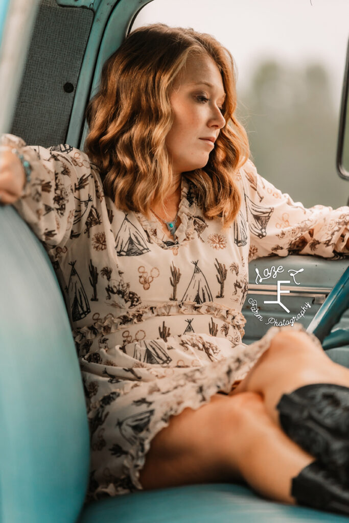 Kayla sitting in truck seat with legs crossed on the bench seat